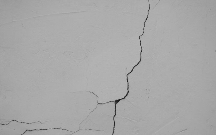 Long crack running across a white painted surface