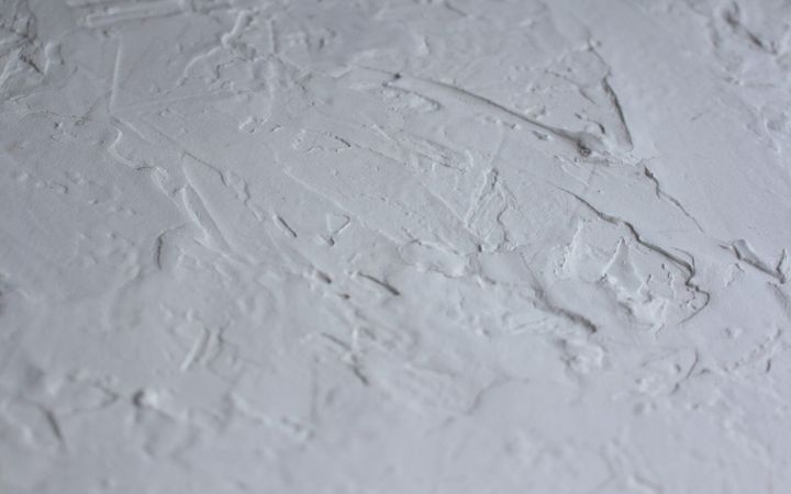 Close-up of a hand-troweled white wall texture