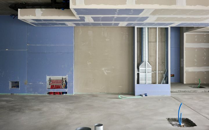 Commercial space with new drywall walls and metal framing overhead